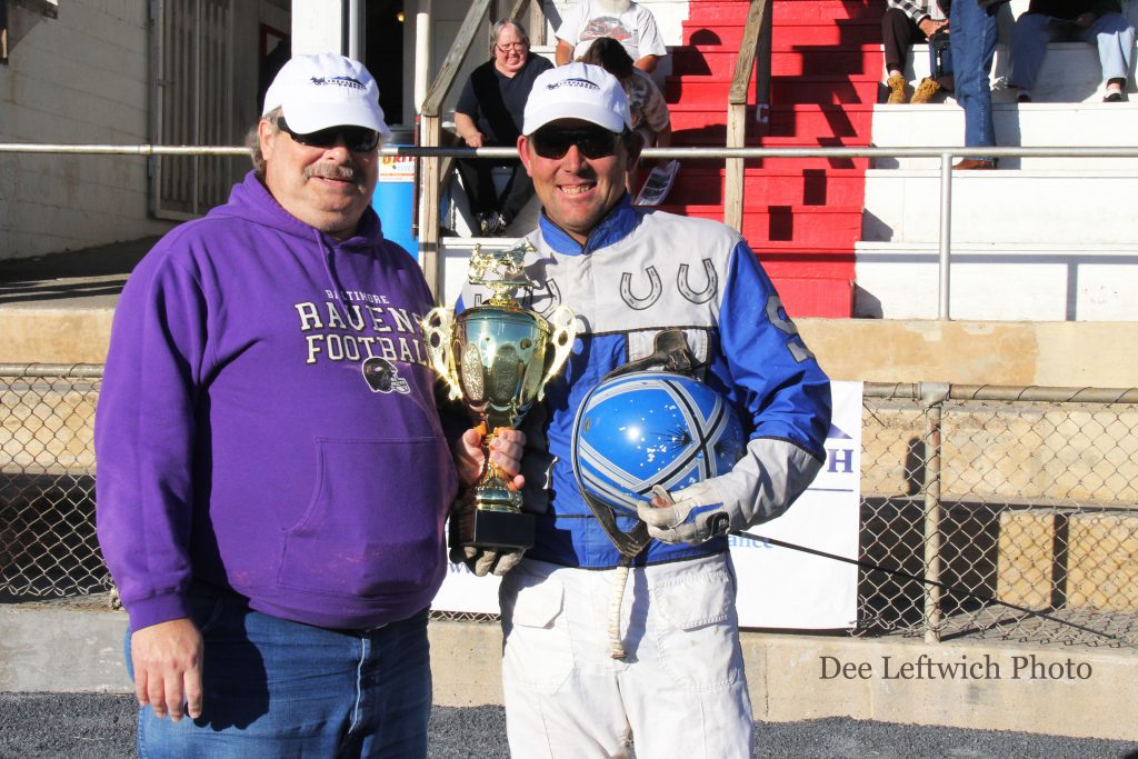 Leading driver Tyler Shehan accepts a trophy from Racing Secretary Mike Wandishin. Photo by Dee Leftwich.